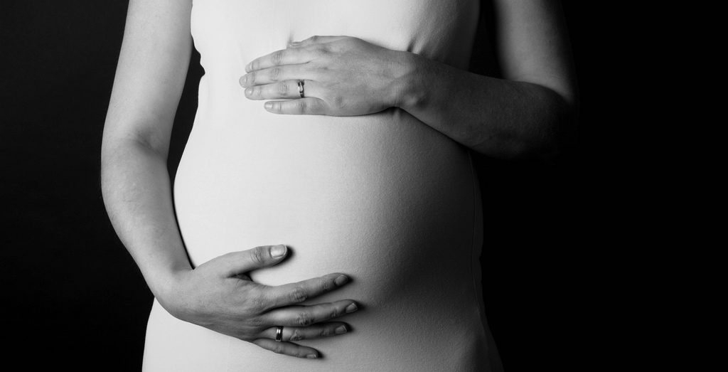 black and white photo of pregnant women