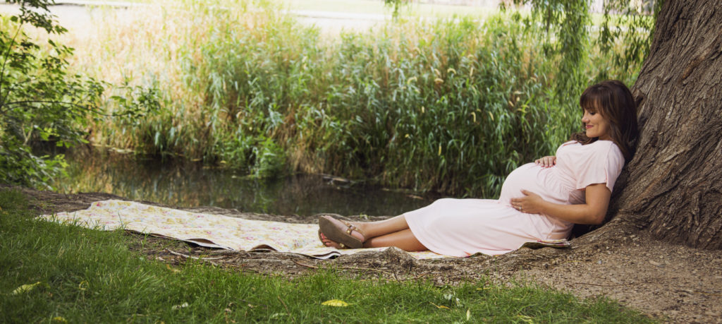 Pregnant women having a picnic outdoors
