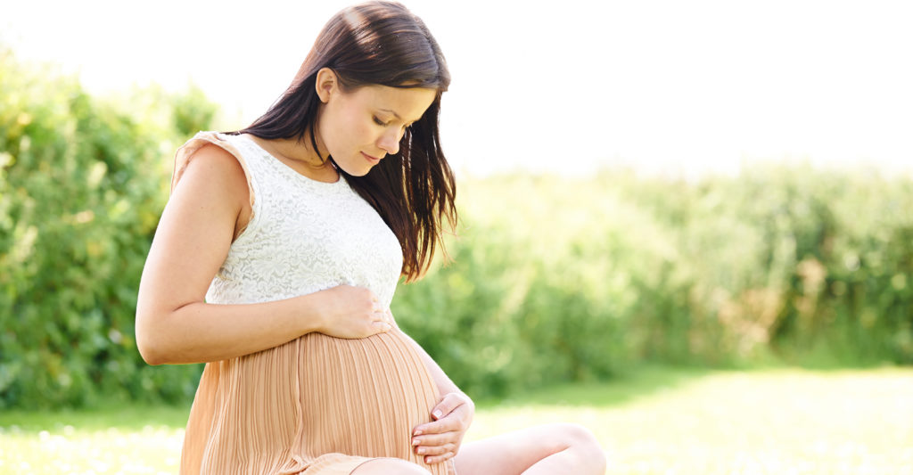 pregnant women sitting outdoors