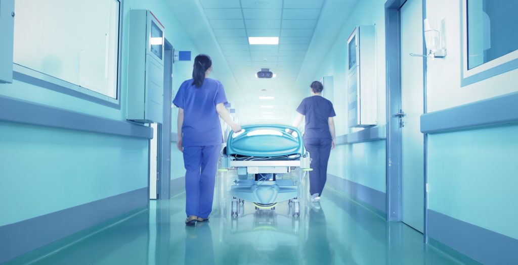 Nurses pushing a patient into surgery