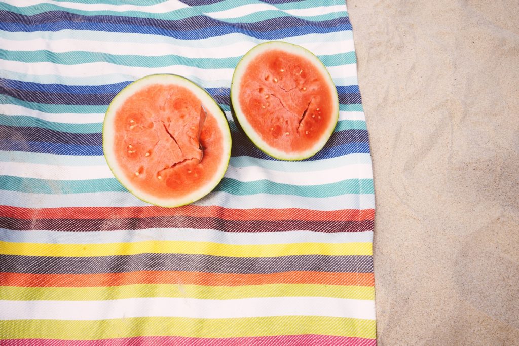 Watermelon on a beach towel at the beach